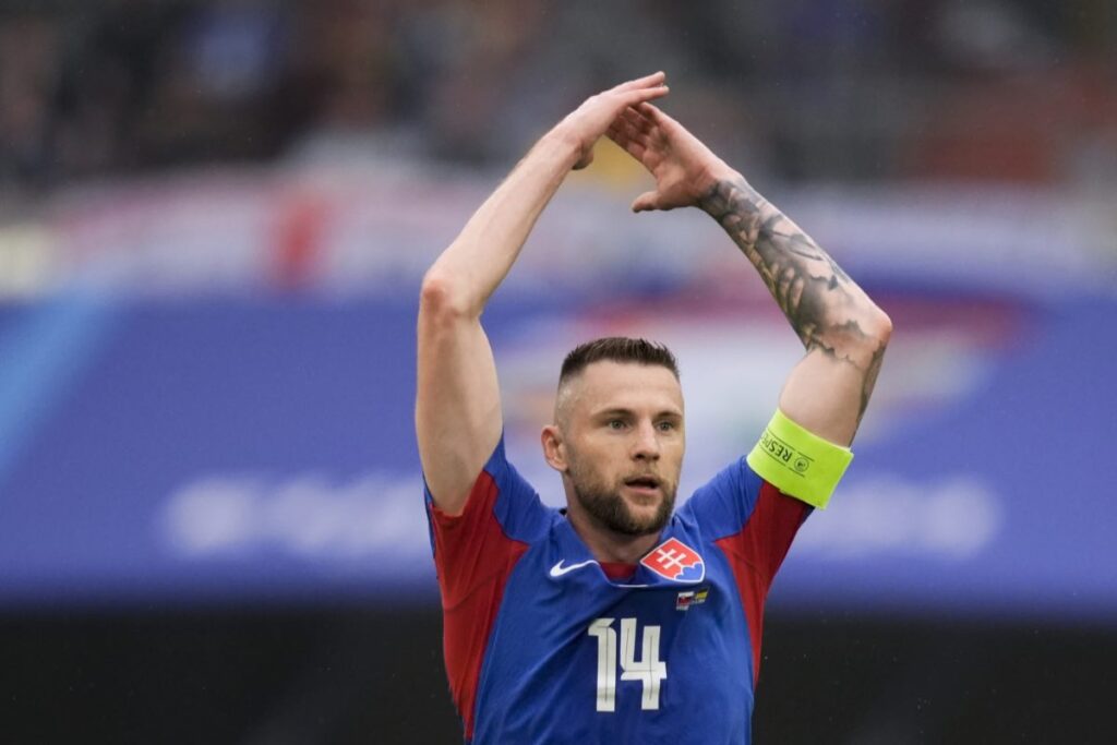 Skriniar con le braccia in alto