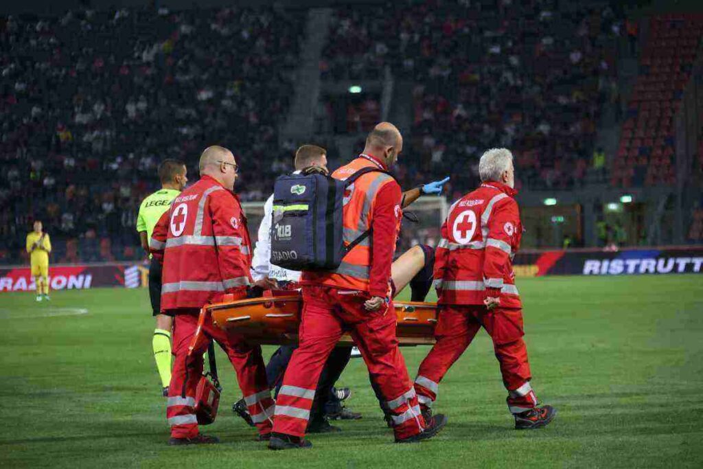 giocatore portato fuori in barella per infortunio