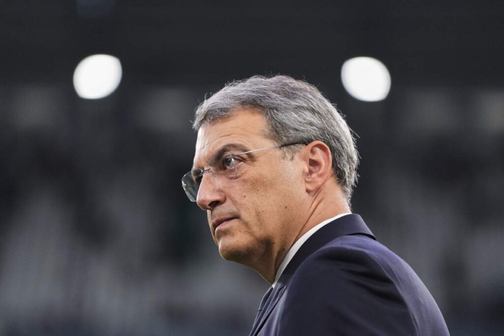 Comolli osserva in abiti dirigenziali